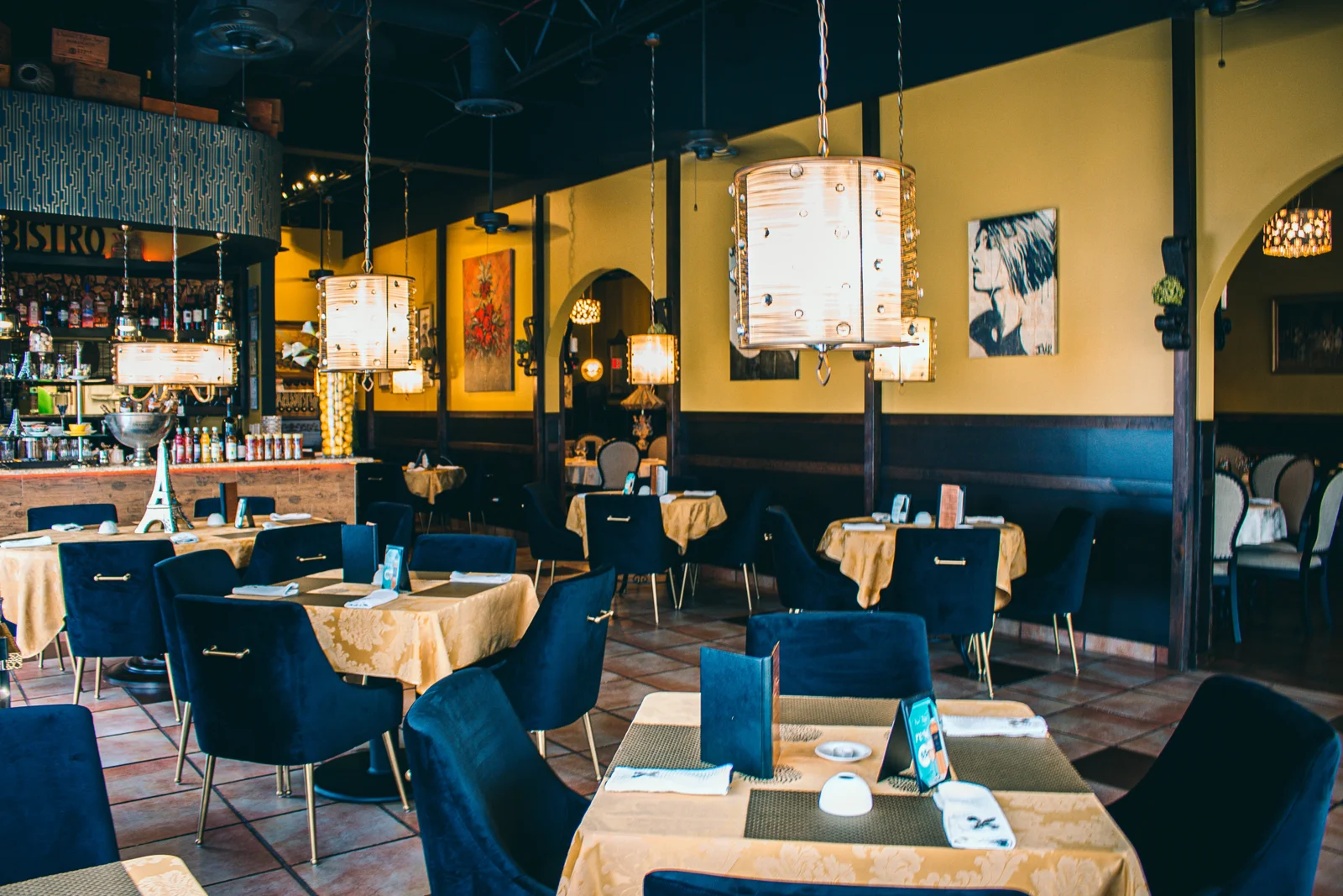 Our dining room, with velvet chairs and warm pendant lights